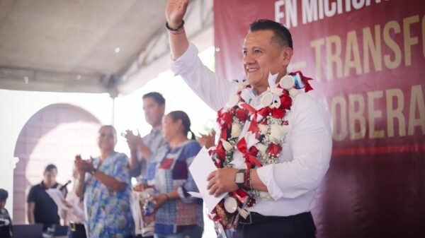 Carlos Torres Piña hablando ante una multitud en la plaza principal de Tiripetío, Michoacán, durante una asamblea informativa