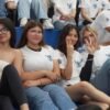 Gráfica o imagen simbólica de estudiantes universitarios en Michoacán con logos de programas educativos estatales como Jóvenes Escribiendo el Futuro y Gertrudis Bocanegra