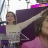 brissa arroyo segundo informe: Brissa Arroyo Martínez hablando ante micrófono en evento público en Morelia, con bandera de