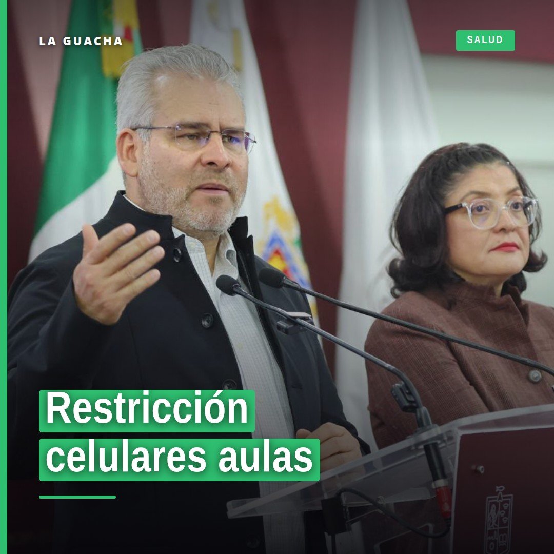 Ilustración simbólica de un celular bloqueado sobre un escritorio escolar en una aula de educación básica en Michoacán, con