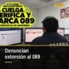 Ilustración de un teléfono móvil mostrando el número 089 con fondo azul y símbolo de escudo, representando la acción de