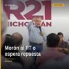 Raúl Morón Orozco hablando ante micrófono en evento político en Morelia, con logo del Partido del Trabajo visible en fondo